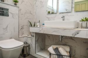 a white bathroom with a sink and a toilet at VILLA ROSA in Troulos +58 photos