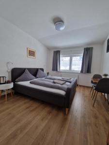 a bedroom with a large bed and a wooden floor at Pension Bergfried in Hallstatt