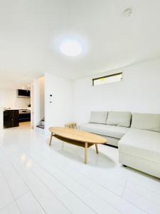 a living room with a couch and a coffee table at Shinjuku House in Tokyo