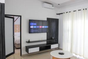 uma sala de estar com televisão na parede em Deluxe Residence - Windhoek em Windhoek