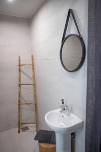 a bathroom with a sink and a mirror at Hõbekala Guesthouse in Kalana