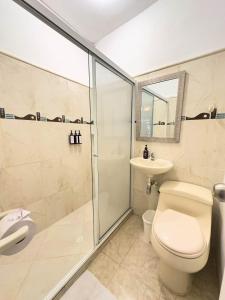 a bathroom with a shower and a toilet and a sink at Curazao Hotel -Centro Histórico- in Santa Fe de Antioquia