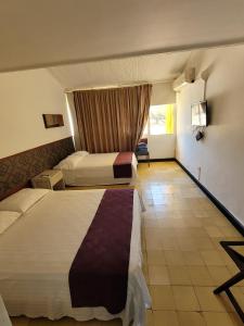 Ένα ή περισσότερα κρεβάτια σε δωμάτιο στο Hotel Gimaura