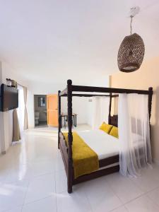 a bedroom with a bed and a tv in a room at Curazao Hotel -Centro Histórico- in Santa Fe de Antioquia