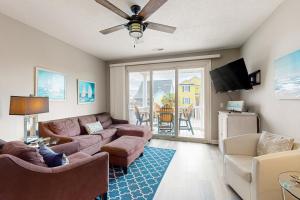 a living room with a couch and a tv at Seaside Unit C in Myrtle Beach