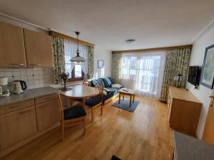 a kitchen and living room with a table and a couch at Schütterhof in Ramsau am Dachstein