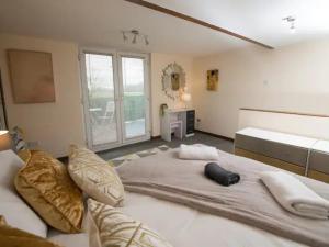 a large bed in a room with a large window at Pass the Keys Large Family House near Lincoln in North Hykeham