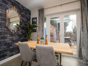 a dining room with a wooden table and a mirror at Pass the Keys Large Family House near Lincoln in North Hykeham