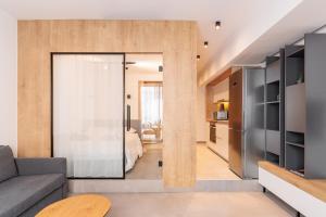 a living room with a sliding door leading to a bedroom at SKG Cityscape Metropolis in Thessaloniki