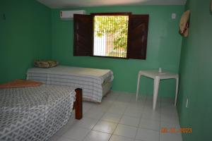 Lova arba lovos apgyvendinimo įstaigoje Casa Coqueiro