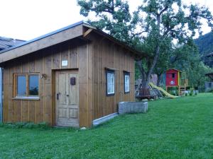 a small wooden building in a field of grass at Ferienwohnung Martina in Schlitters