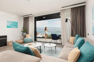 a living room with a couch and a view of the ocean at Nikki Beach Resort & Spa Montenegro in Tivat