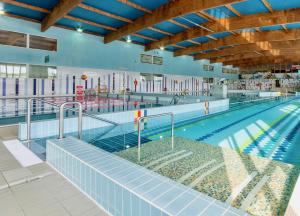 a large swimming pool with a poolwalk in the middle at Apartament Darłówko in Darlowko