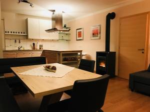 a kitchen with a wooden table and a stove at Ferienwohnung Martina in Schlitters