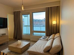 a bedroom with a bed and a large window at Koru, Finnish Design Suite in Rovaniemi