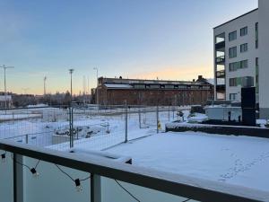 a parking lot with snow on the ground at Koru, Finnish Design Suite in Rovaniemi