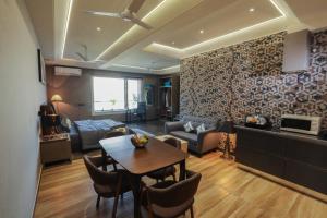 ein Wohnzimmer mit einem Tisch und einem Sofa in der Unterkunft KRYC Luxury Living in Neu-Delhi