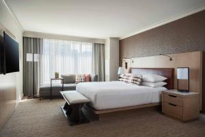 a hotel room with a large bed and a couch at Baltimore Marriott Waterfront in Baltimore