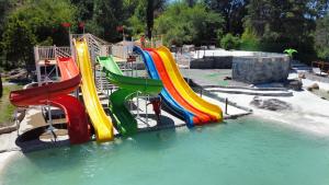 a water park with a slide in the water at Capri Hotel y Cabañas by CPH in Villa Carlos Paz