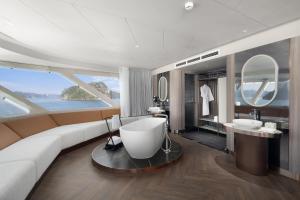 a living room with a couch and a bathroom at Grand Pioneers Halong Bay Cruise 1 in Ha Long