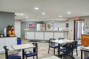 a restaurant with tables and chairs and a counter at Days Inn by Wyndham Sturgis in Sturgis