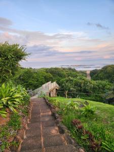 a pathway leading up to a hill with a view of the ocean at Lamer Holiday Apartment 66 in Kingsburgh