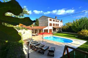 a villa with a swimming pool and a house at Villa Moncalvo in Bale