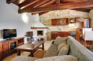a living room with a couch and a fireplace at Villa Moncalvo in Bale