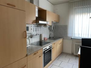 a kitchen with a sink and a stove top oven at Ferienhaus Brandes Wohnung 2 in Norderney +7 photos