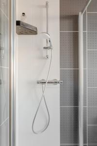a shower with a shower head in a bathroom at Room in Guest room - Apple House Wembley Twin Room in Edgware