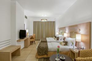 Posteľ alebo postele v izbe v ubytovaní Toledo Amman Hotel