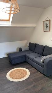 a blue couch sitting in a living room at L'appartement de Julie in Albert