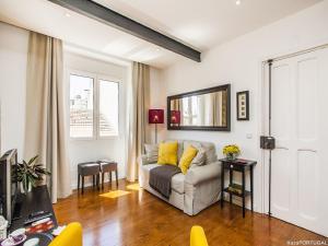 a living room with a couch and a television at Calado Apartments in Lisbon