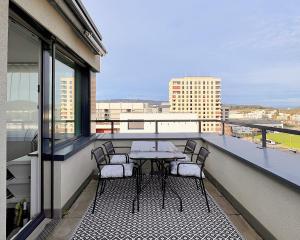 - Balcón con mesa y sillas en un edificio en Beautiful Apartment 10 min from Zurich! Netflix!, en Schlieren