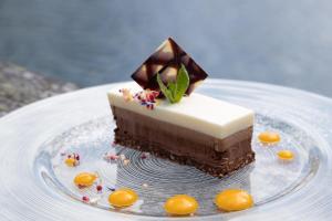 un trozo de pastel de chocolate en un plato en Hotel Restaurant Seehaus Mountain Lake Resort en San Giuseppe in Anterselva