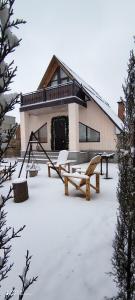 a house with snow on the ground in front of it at Qusar-A-frame in Qusar