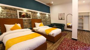 En eller flere senge i et værelse på Destination Hotel Thandiani