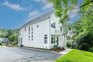 a white house with a driveway at New Townhome Near Downtown-King Bed/Workstation in Naperville