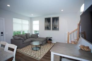 a living room with a couch and a table at New Townhome Near Downtown-King Bed/Workstation in Naperville