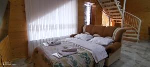 a bedroom with a bed with two towels on it at Qusar-A-frame in Qusar
