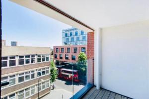 a view from the balcony of a building with a bus at Impeccable 1-Bed Apartment in London in London