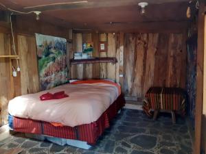 a bedroom with a bed in a wooden room at Earthship amazing Cabins with lake view in San Marcos La Laguna