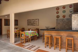 a dining room with a table and chairs and plates on the wall at Pousada Meia Ponte in Pirenópolis