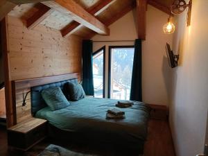 a bedroom with a bed in a room with a window at Chalet Kelly in Les Orres