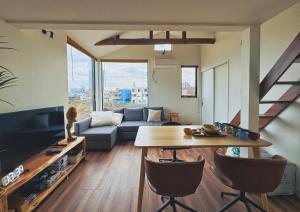 a living room with a couch and a table at 枕木 New house with Huge View for Family-Group in Tokyo