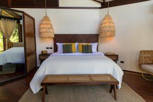 Кровать или кровати в номере Mantaray Siargao