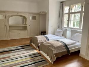 Cama ou camas em um quarto em Kavaliershaus Krumke - Gästehaus im Schlosspark