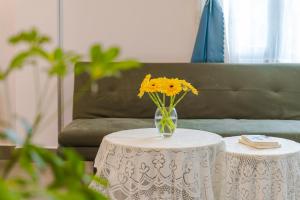 eine Vase gelber Blumen auf einem Tisch in der Unterkunft Kim Little House Hotel in Da Lat