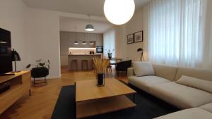 a living room with a couch and a table at Bratislava OLDTOWN Apartment 130m2 ,60m2 terrace and 2 bathrooms in Bratislava