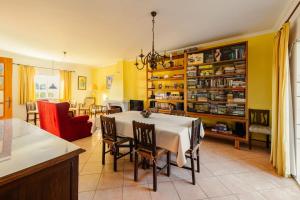 een keuken en eetkamer met een tafel en stoelen bij Moradia T3 Com Terraço Solarengo in Carrapateira